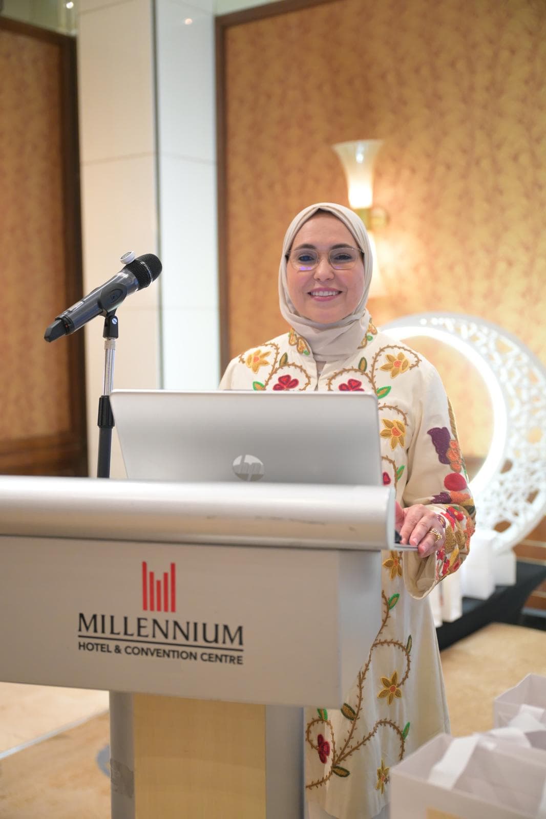 Eng. Radwa Galal coaching mathematics at a podium.